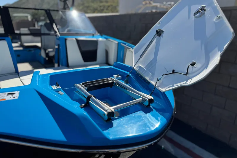 Slide: The Image of 2023 Yamaha Boats 222XD with open hatch and ladder, showcasing sleek blue design. - 12