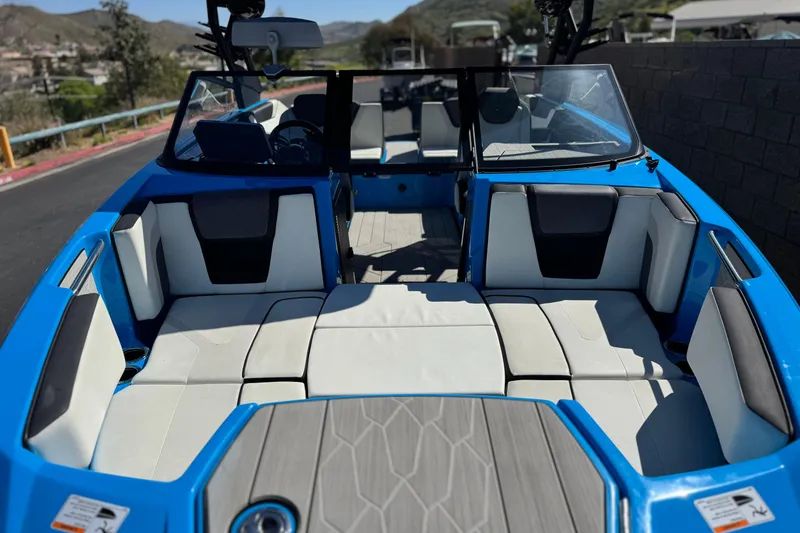 Slide: The Image of 2023 Yamaha Boats 222XD interior with blue and white seating, open deck view. - 13