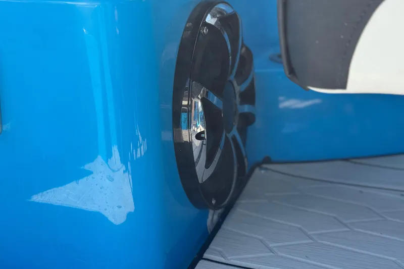 Slide: The Image of 2023 Yamaha Boats 222XD speaker detail on blue hull. - 25