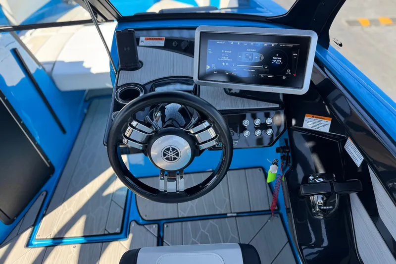 Slide: The Image of 2023 Yamaha Boats 222XD cockpit with steering wheel and digital display. - 28