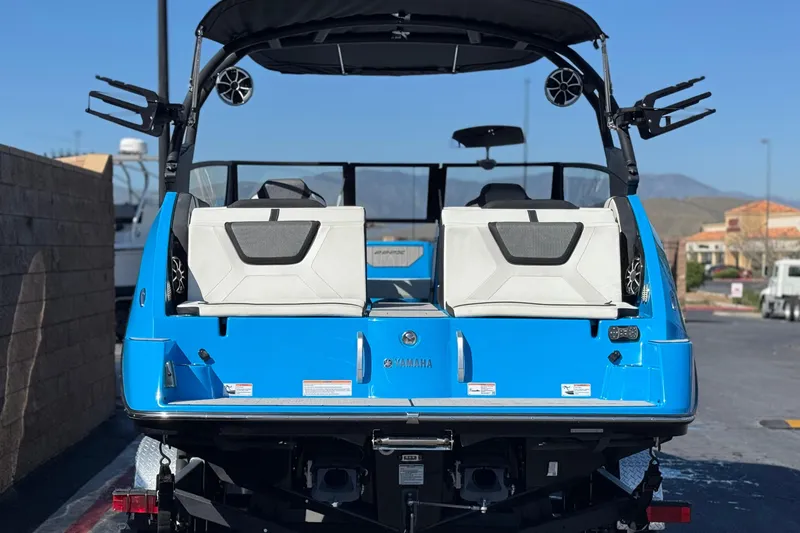 Slide: The Image of 2023 Yamaha Boats 222XD, blue exterior, rear view, parked outdoors. - 4