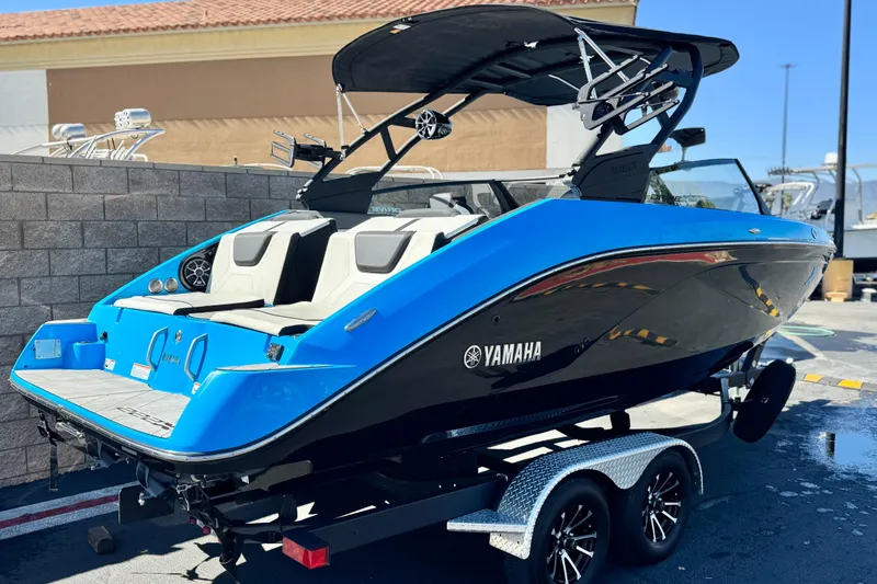 Slide: The Image of 2023 Yamaha Boats 222XD in vibrant blue, parked on a trailer. - 5