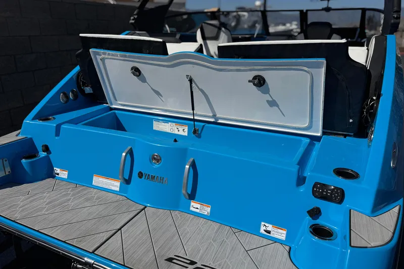 Slide: The Image of 2023 Yamaha Boats 222XD, blue exterior, open storage compartment, modern design. - 7