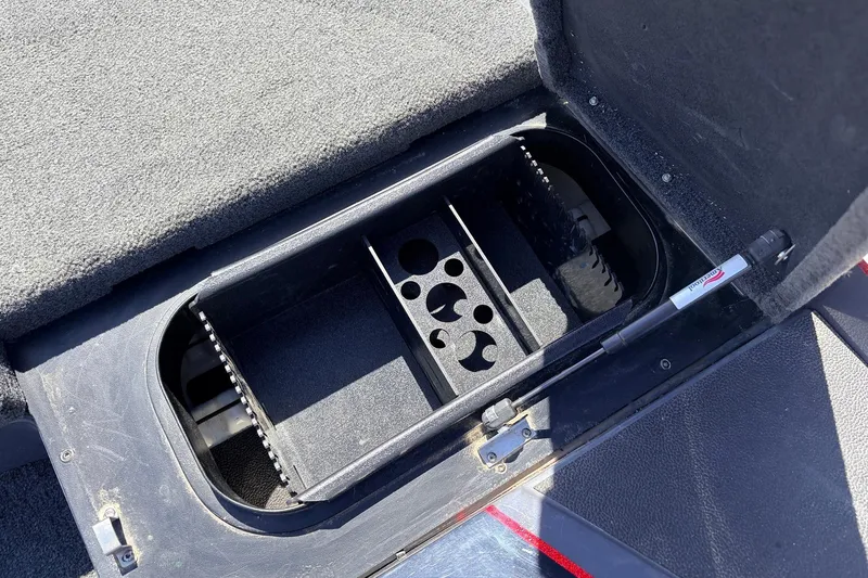 Slide: The Image of Open storage compartment in 2019 Skeeter FX21 Apex boat, featuring organized interior layout. - 17