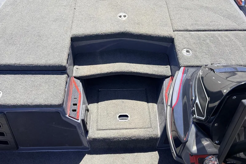 Slide: The Image of 2019 Skeeter FX21 Apex boat interior with carpeted deck and storage compartments. - 18