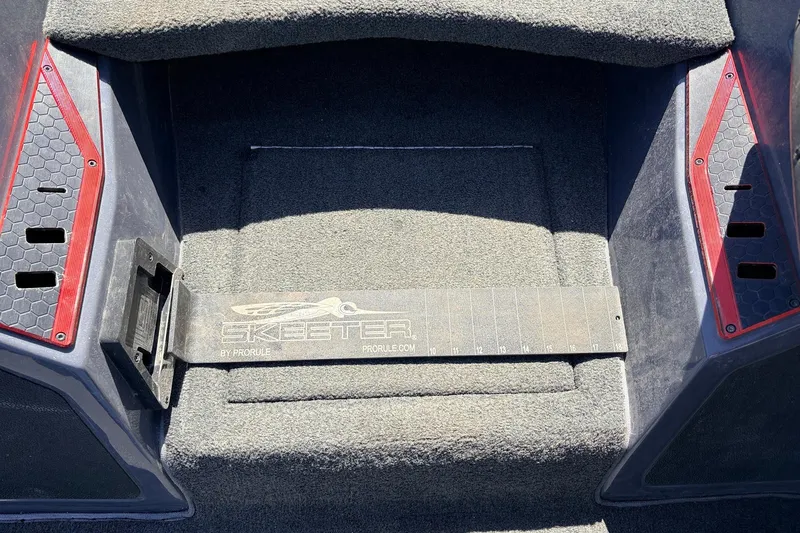 Slide: The Image of 2019 Skeeter FX21 Apex boat interior with carpeted flooring and branded measuring board. - 20