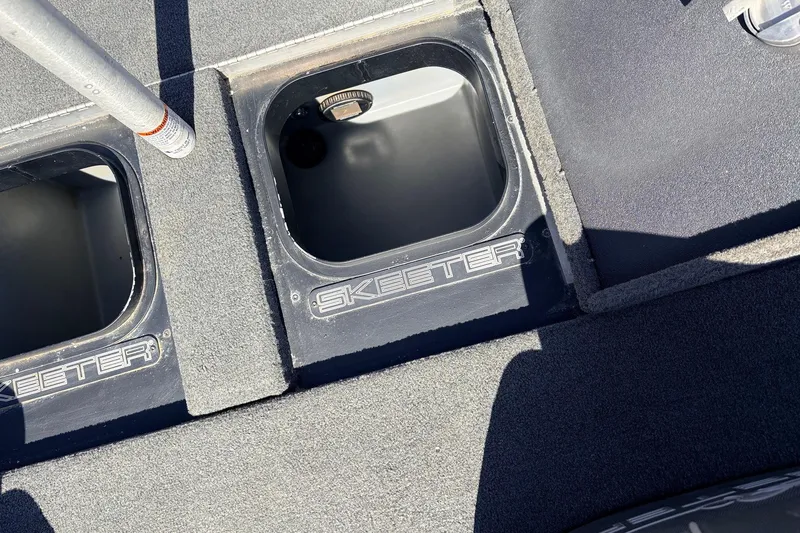Slide: The Image of 2019 Skeeter FX21 Apex boat storage compartments with Skeeter branding. - 29