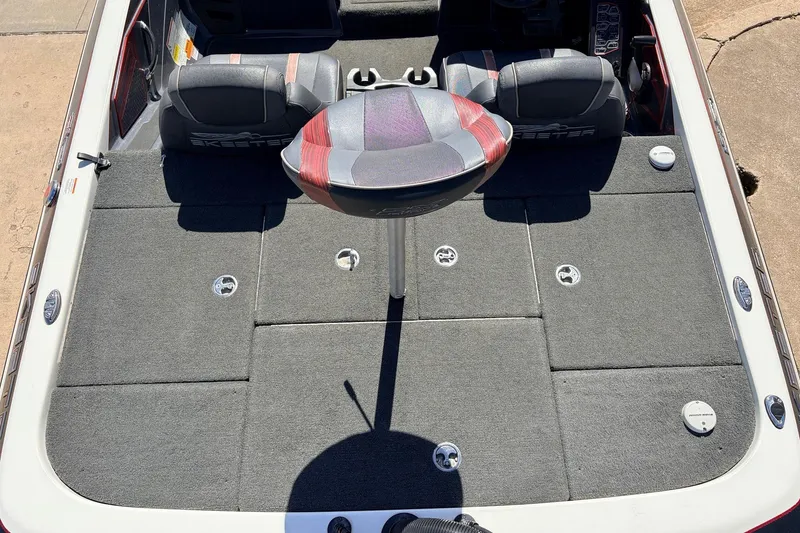 Slide: The Image of 2019 Skeeter FX21 Apex boat interior with gray carpet and seating. - 30