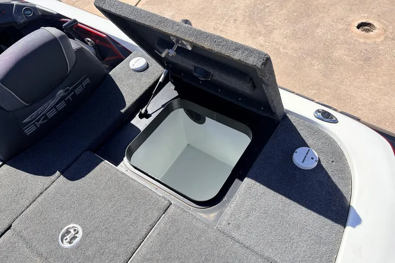 Slide: The Image of 2019 Skeeter FX21 Apex boat with open storage compartment and cushioned seating. - 34