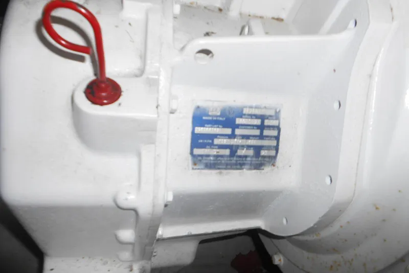 Slide: The Image of Close-up of a 2007 Sea Ray 44 Sundancer engine component with a red handle and identification plate. - 37