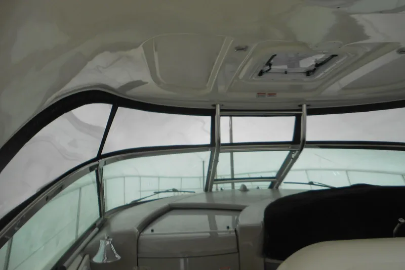 Slide: The Image of 2007 Sea Ray 44 Sundancer helm with Raymarine electronics and wooden steering wheel. - 4