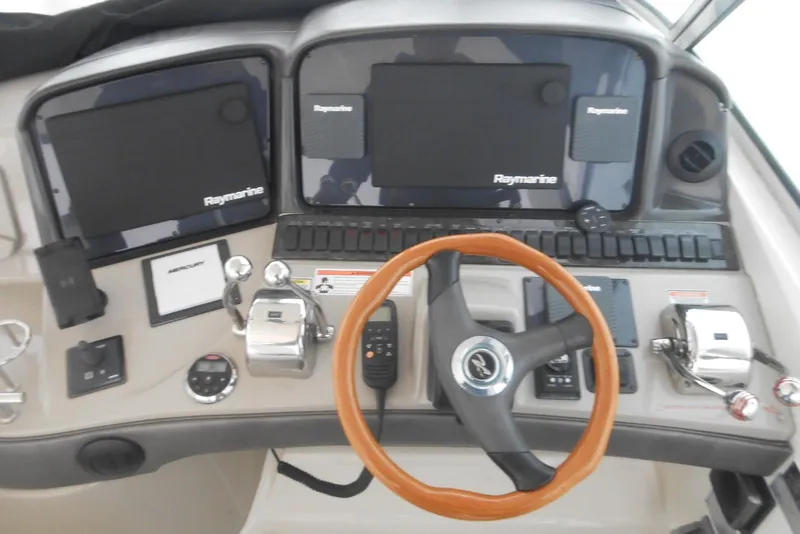 Slide: The Image of Control panel of 2007 Sea Ray 44 Sundancer with steering wheel and navigation screens. - 5