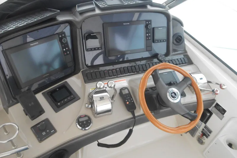 Slide: The Image of 2007 Sea Ray 44 Sundancer interior with white seating and wooden table. - 6