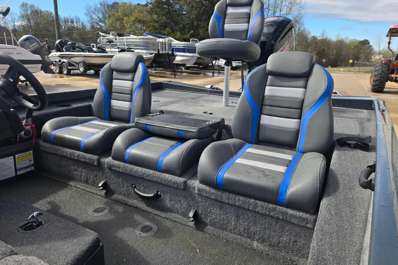 Slide: The Image of 2023 Ranger RT188P boat interior with gray and blue seating, steering wheel, and console. - 11