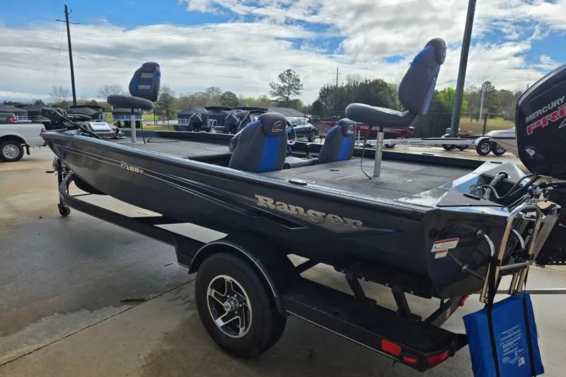 Slide: The Image of 2023 Ranger RT188P fishing boat on trailer, featuring elevated seats and Mercury Pro XS engine. - 2