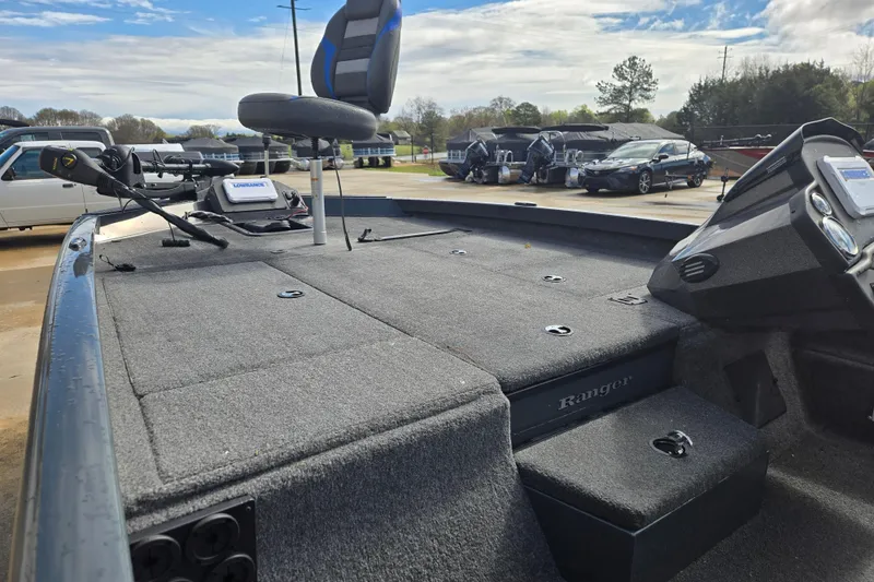 Slide: The Image of 2023 Ranger RT188P boat interior with seating and control panel, parked outdoors. - 9