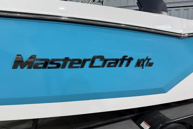 Slide: The Image of 2020 MasterCraft NXT22 boat with blue and white exterior, featuring bold logo. - 3