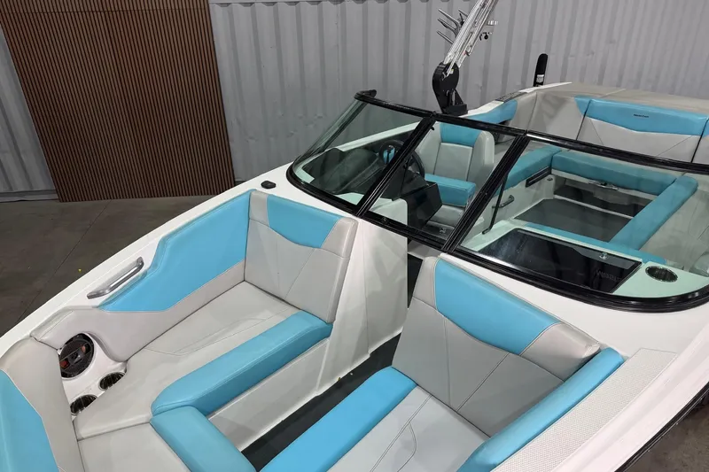 Slide: The Image of 2020 MasterCraft NXT22 boat interior with blue and white seating, sleek design. - 4