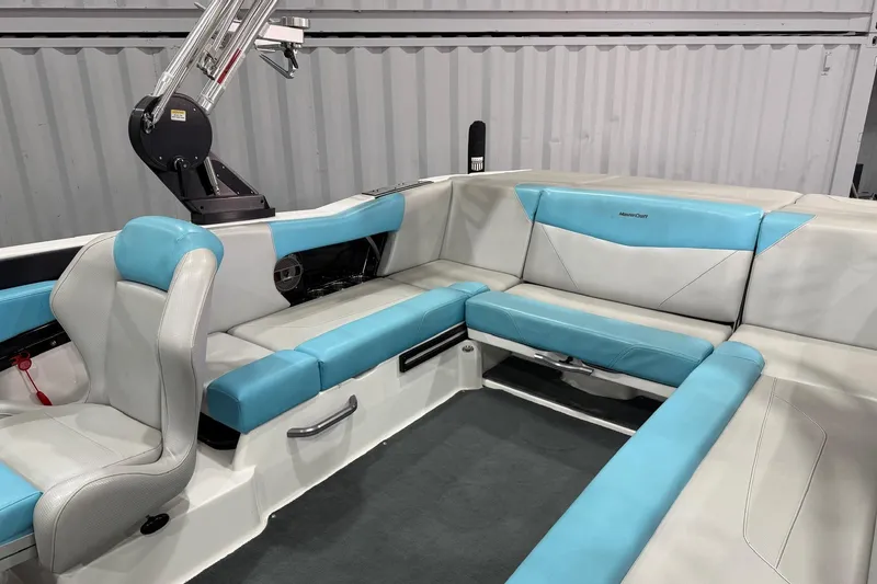Slide: The Image of 2020 MasterCraft NXT22 boat interior with blue and white seating, modern design. - 6