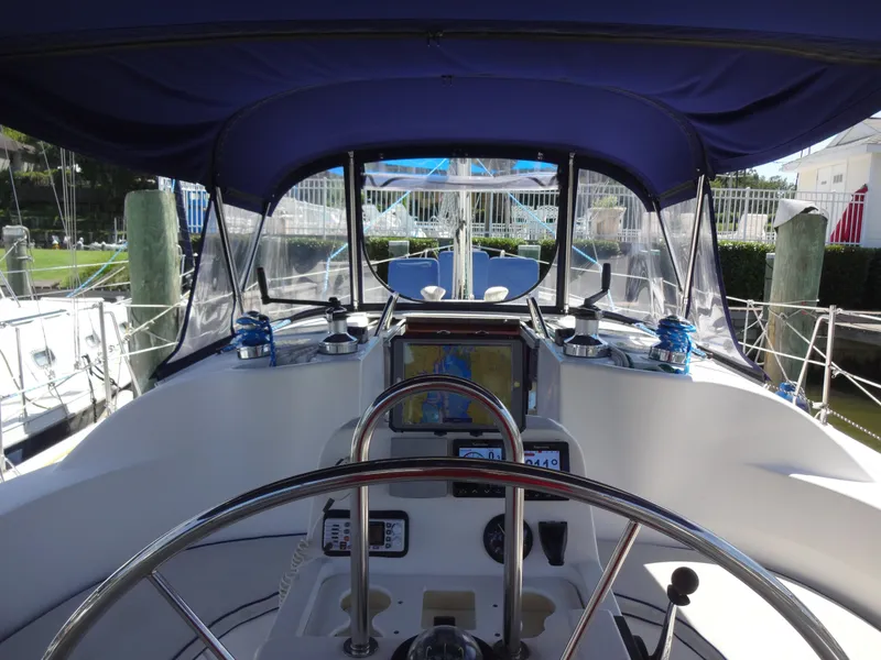 Slide: The Image of Cockpit of a 2001 Hunter 380 yacht with blue canopy. - 11