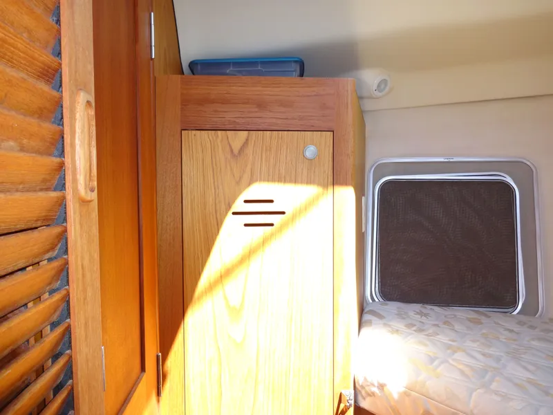 Slide: The Image of Interior of a 2001 Hunter 380 yacht with wooden cabinet and window. - 39