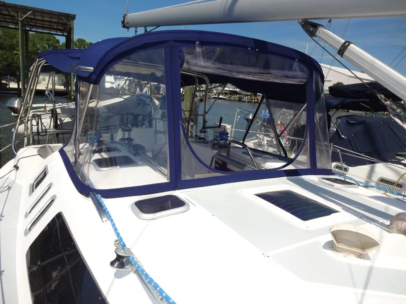 Slide: The Image of 2001 Hunter 380 sailboat with blue cover in marina. - 8