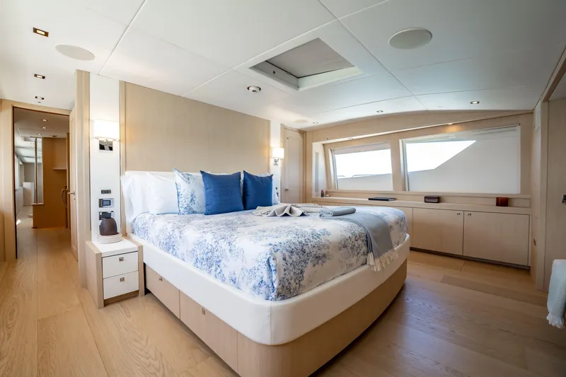 Slide: The Image of Luxurious bedroom interior on a 2011 Sunseeker 34 Metre Yacht, featuring elegant decor and large windows. - 48