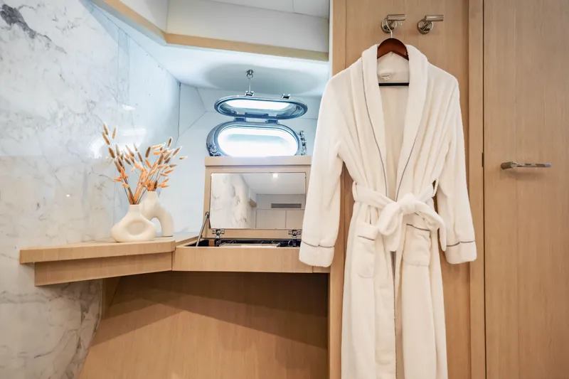 Slide: The Image of Luxurious yacht interior with robe, elegant decor, and porthole window on Sunseeker 34 Metre Yacht. - 55