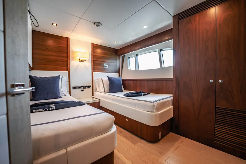 Slide: The Image of Luxurious twin cabin interior on 2011 Sunseeker 34 Metre Yacht, featuring elegant wood finishes. - 67