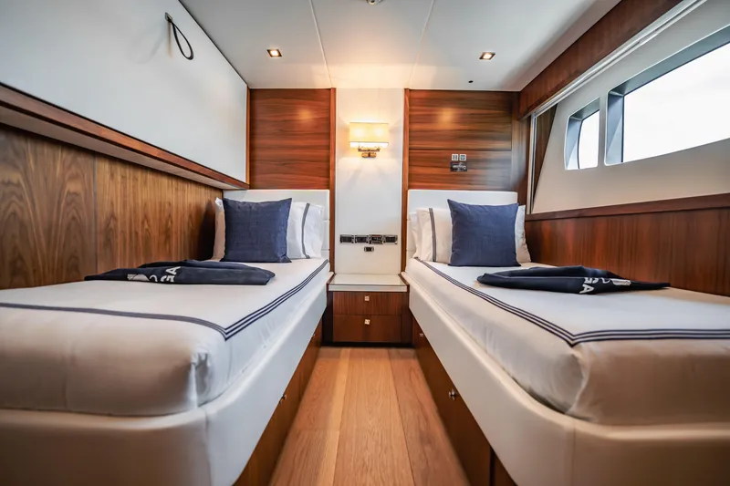 Slide: The Image of Luxurious twin cabin interior on 2011 Sunseeker 34 Metre Yacht, featuring elegant wood paneling. - 68