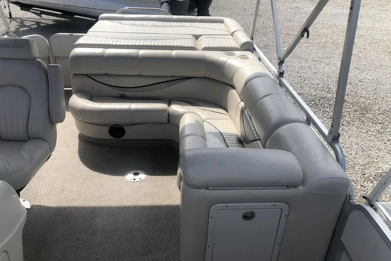 Slide: The Image of 2008 South Bay 822 CR Tritoon interior with beige seating and carpeted floor. - 4