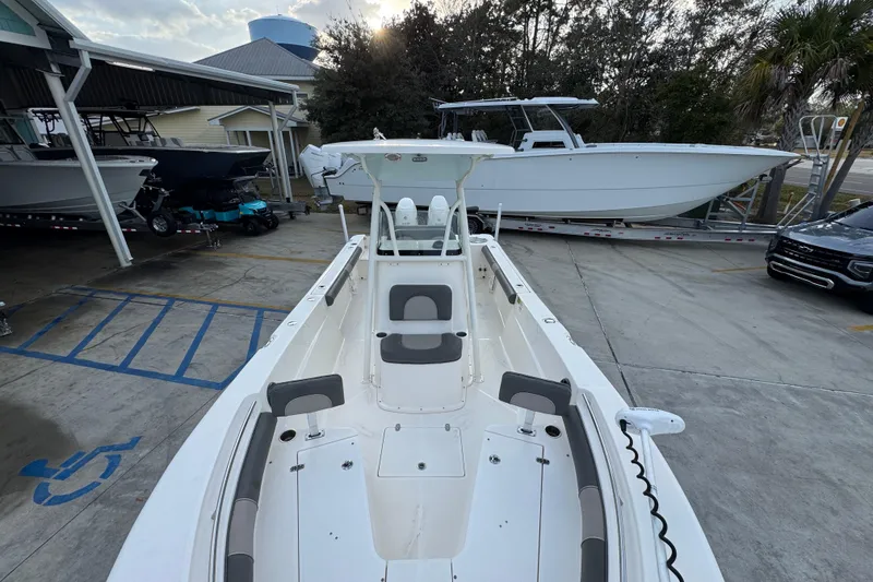 Slide: The Image of 2021 Sea Born LX24 Center Console boat in a marina parking area. - 21
