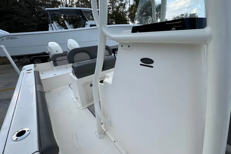 Slide: The Image of 2021 Sea Born LX24 Center Console boat interior with seating and console details. - 24