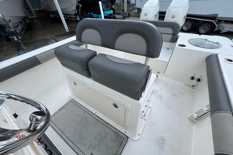 Slide: The Image of 2021 Sea Born LX24 Center Console boat interior with dual seating and steering wheel. - 27