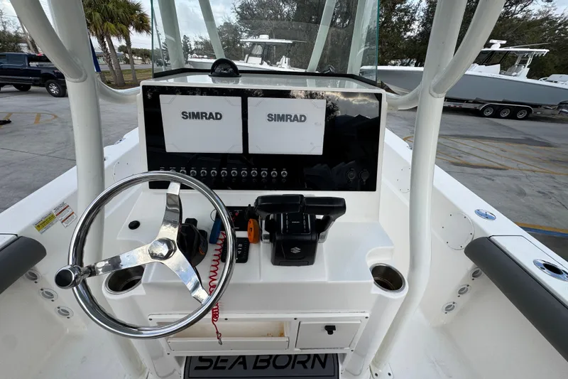 Slide: The Image of 2021 Sea Born LX24 Center Console boat dashboard with dual Simrad displays. - 29