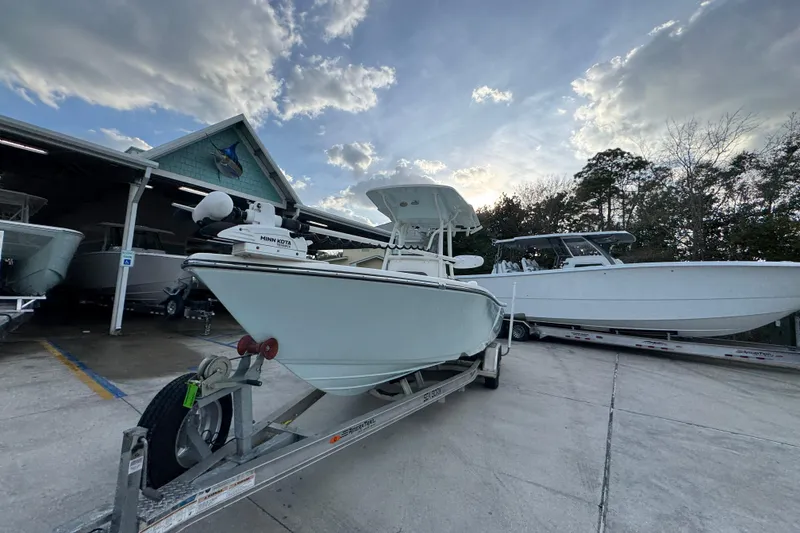 Slide: The Image of 2021 Sea Born LX24 Center Console boat on trailer under cloudy sky. - 3