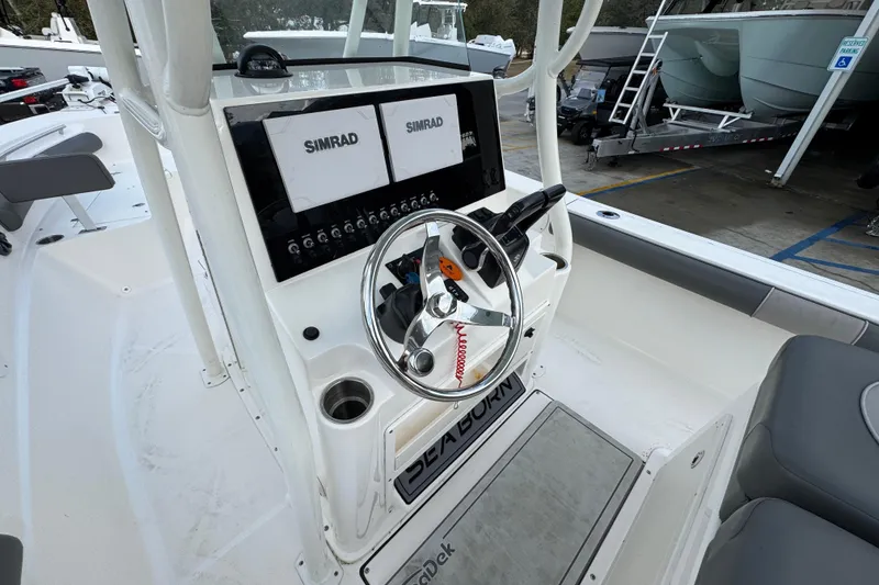 Slide: The Image of 2021 Sea Born LX24 Center Console boat interior with steering wheel and Simrad displays. - 30