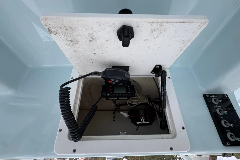 Slide: The Image of 2021 Sea Born LX24 Center Console storage compartment with radio equipment and wiring. - 33