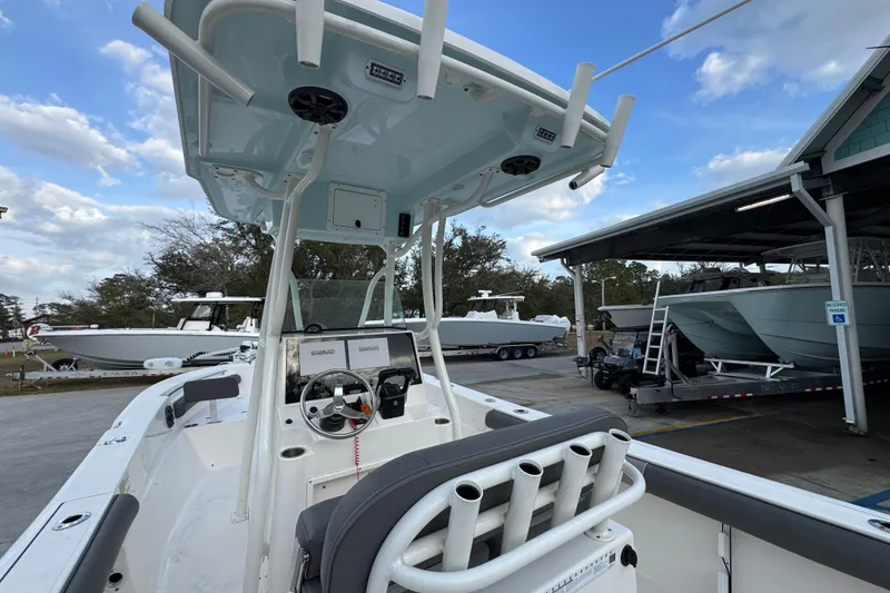 Slide: The Image of 2021 Sea Born LX24 Center Console boat at a marina, showcasing helm and seating. - 34