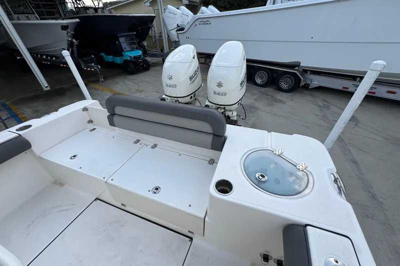 Slide: The Image of 2021 Sea Born LX24 Center Console boat with dual Suzuki 140 engines, docked in a marina. - 37