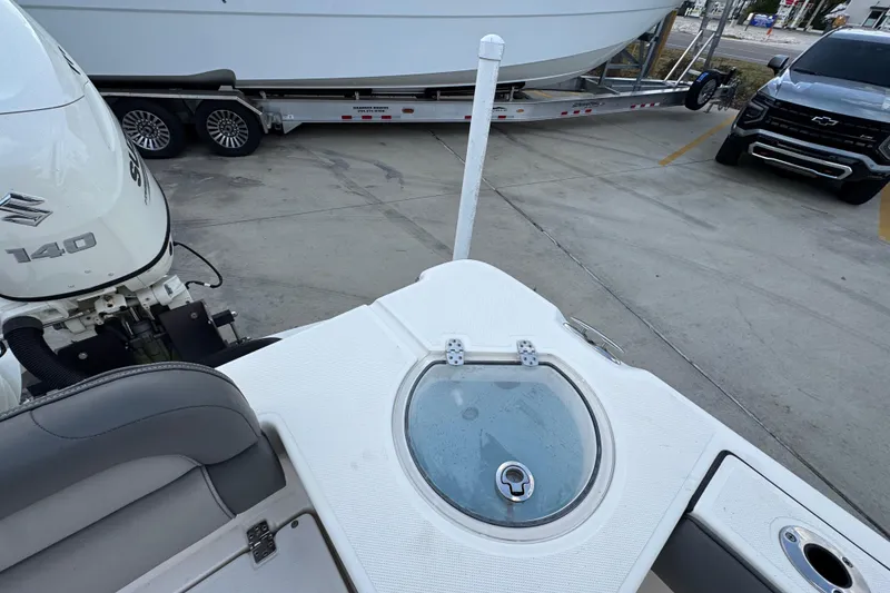 Slide: The Image of 2021 Sea Born LX24 Center Console boat with Suzuki 140 engine, parked near a trailer and truck. - 38