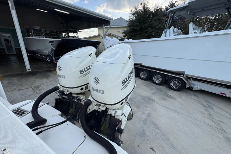 Slide: The Image of Twin Suzuki 140 outboard engines on a 2021 Sea Born LX24 Center Console boat. - 39