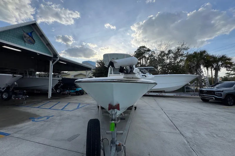 Slide: The Image of 2021 Sea Born LX24 Center Console boat on trailer at dealership under cloudy sky. - 5