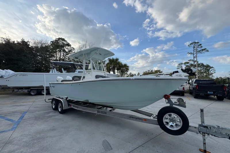 Slide: The Image of 2021 Sea Born LX24 Center Console boat on trailer under cloudy sky. - 7