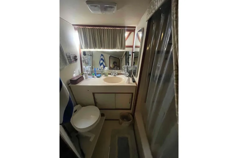 Slide: The Image of 1987 Chris-Craft 426 Catalina interior with cozy seating and wooden accents. - 10