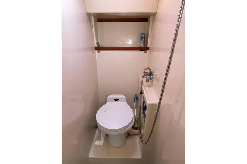 Slide: The Image of 1987 Chris-Craft 426 Catalina cabin interior with mirrored vanity and tropical bedding. - 12