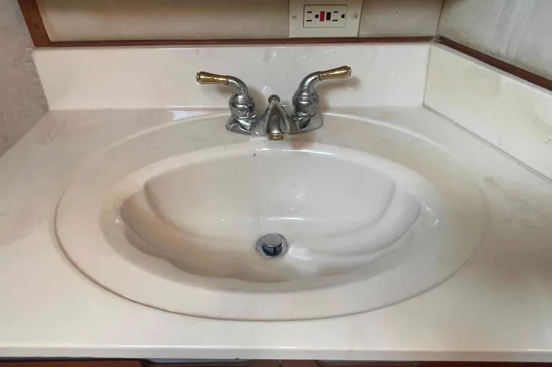 Slide: The Image of Closet inside 1987 Chris-Craft 426 Catalina yacht with hanging clothes and fire extinguisher. - 13