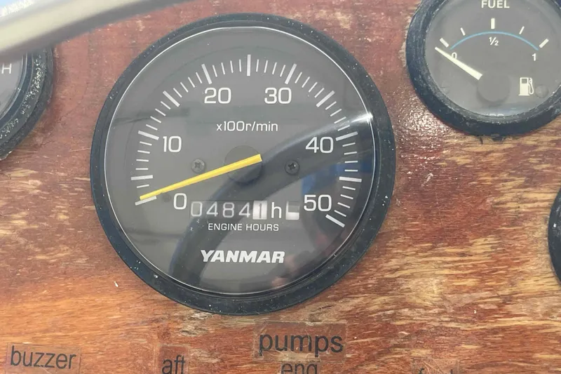 Slide: The Image of Electrical control panel of 1987 Chris-Craft 426 Catalina yacht, featuring gauges and switches. - 26