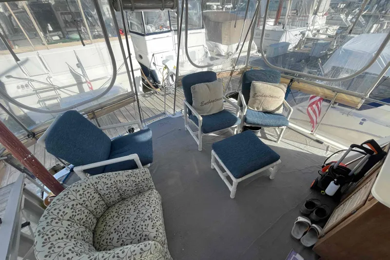 Slide: The Image of 1987 Chris-Craft 426 Catalina yacht interior with seating, cabinetry, and marina view. - 4