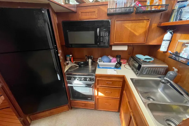 Slide: The Image of Interior of 1987 Chris-Craft 426 Catalina yacht with cozy seating and modern amenities. - 5